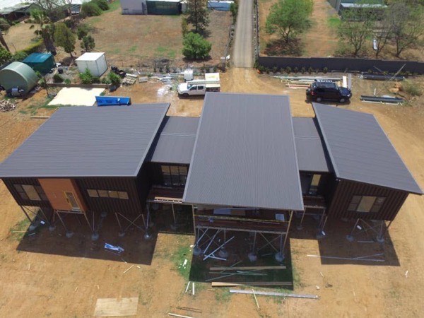 Dark metal roofs on a group of new pavilion buildings, seen from above