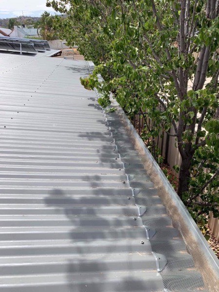 A run of new gutter along the edge of a steel roof