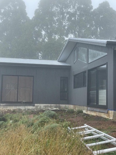 A modern house clad and roofed in grey corrugated steel